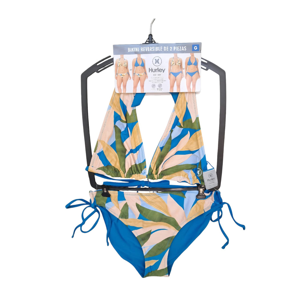 Bikini reversible Hurley colección premium. Top halter con copas suaves, bottom con amarrado lateral. Estampado botánico/color sólido. Tallas M y G. Minicostos RM.