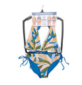 Bikini reversible Hurley colección premium. Top halter con copas suaves, bottom con amarrado lateral. Estampado botánico/color sólido. Tallas M y G. Minicostos RM.